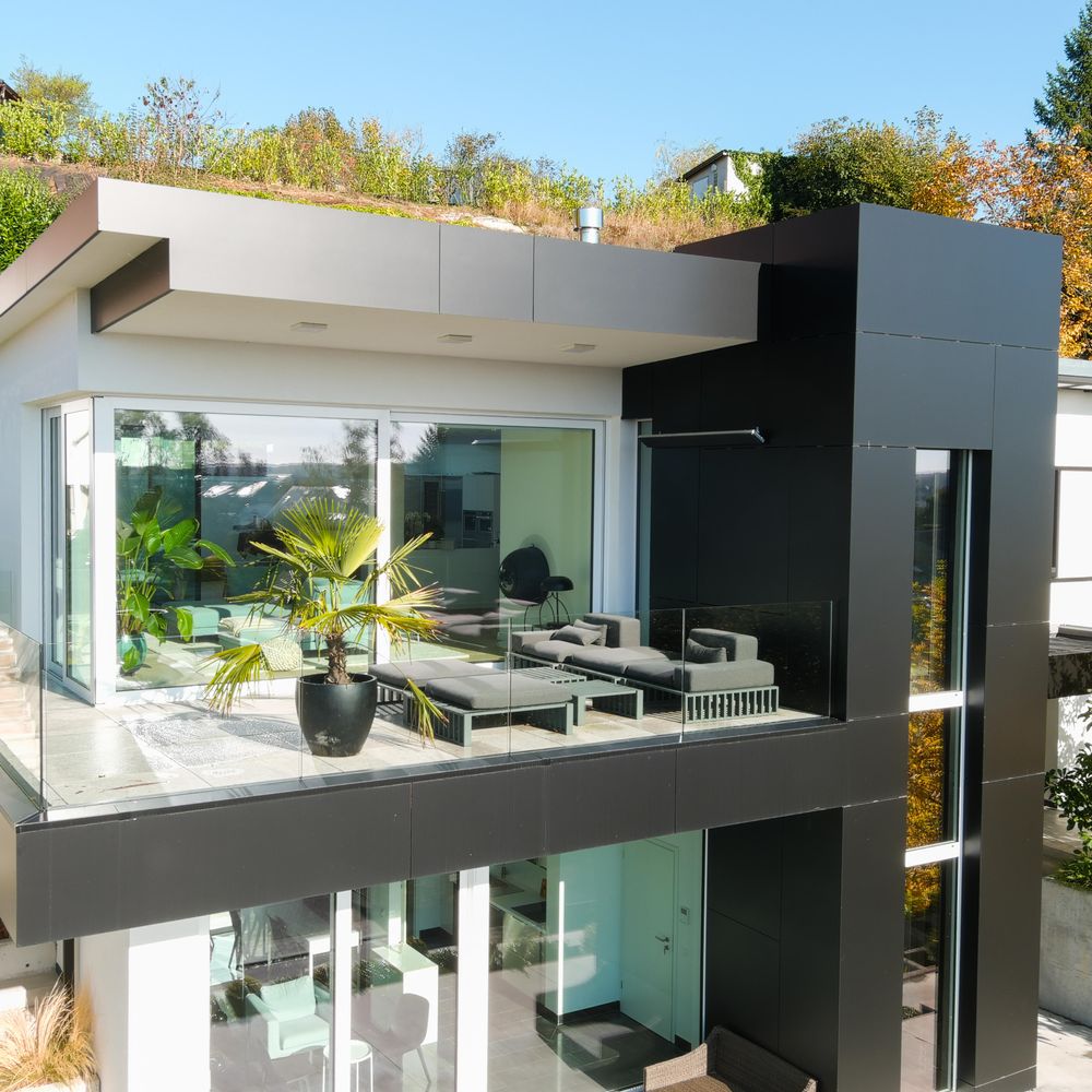 Frameless glass balcony railing on a modern home